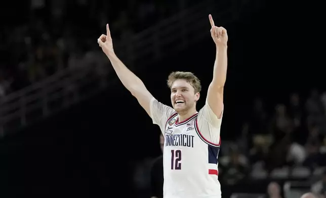 UConn guard Cam Spencer (12) celebrates after their win against Purdue in the NCAA college Final Four championship basketball game, Monday, April 8, 2024, in Glendale, Ariz. (AP Photo/David J. Phillip)