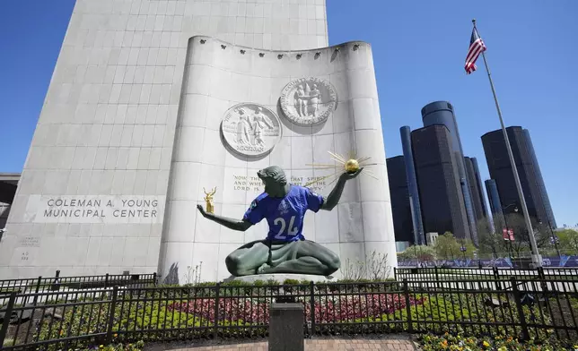 An NFL football draft jersey is displayed on the Spirit of Detroit statue Friday, April 19, 2024, in Detroit. The draft has taken the show on the road for a decade, giving cities a chance around the country a chance to be in the spotlight. The Motor City, which was once one of the nation's largest and most powerful cities, has bounced back from filing for bankruptcy in 2013. (AP Photo/Carlos Osorio)