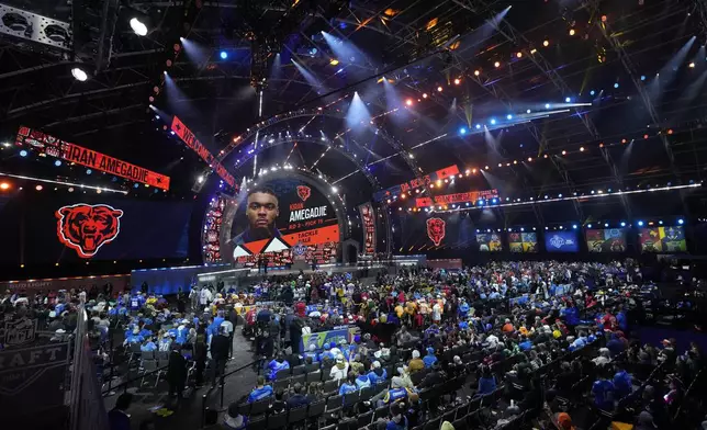 Fans watch during the third round of the NFL football draft, Friday, April 26, 2024, in Detroit. (AP Photo/Paul Sancya)
