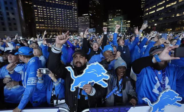 Detroit Lions fans cheer during the second round of the NFL football draft, Friday, April 26, 2024, in Detroit. (AP Photo/Paul Sancya)