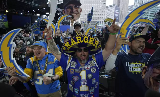 Los Angeles Chargers fans cheer during the second round of the NFL football draft, Friday, April 26, 2024, in Detroit. (AP Photo/Paul Sancya)