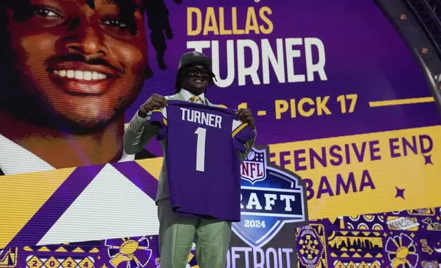 Alabama linebacker Dallas Turner poses being chosen by the Minnesota Vikings with the 17th overall pick during the first round of the NFL football draft, Thursday, April 25, 2024, in Detroit. (AP Photo/Jeff Roberson)