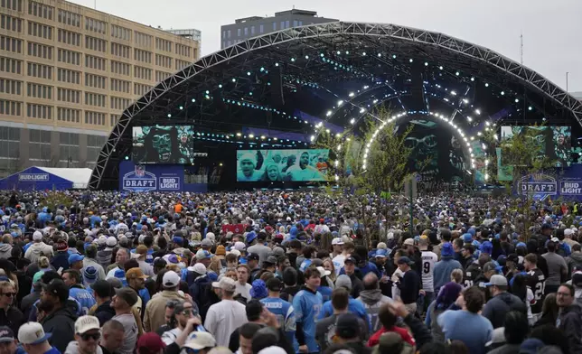 Crowds fill an area outside of the draft stage during the second round of the NFL football draft, Friday, April 26, 2024, in Detroit. (AP Photo/Carlos Osorio)