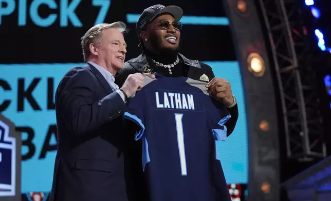 Alabama offensive lineman JC Latham poses with NFL Commissioner Roger Goodell, right, after being chosen by the Tennessee Titans with the seventh overall pick during the first round of the NFL football draft, Thursday, April 25, 2024, in Detroit. (AP Photo/Jeff Roberson)