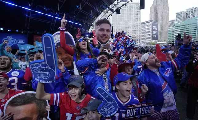 Buffalo Bills fans cheer during the second round of the NFL football draft, Friday, April 26, 2024, in Detroit. (AP Photo/Paul Sancya)