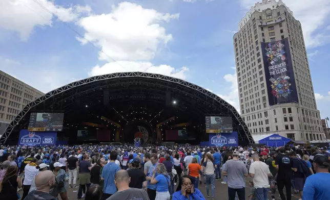 Fans watch the draft stage during the third day of the NFL football draft, Saturday, April 27, 2024, in Detroit. (AP Photo/Paul Sancya)