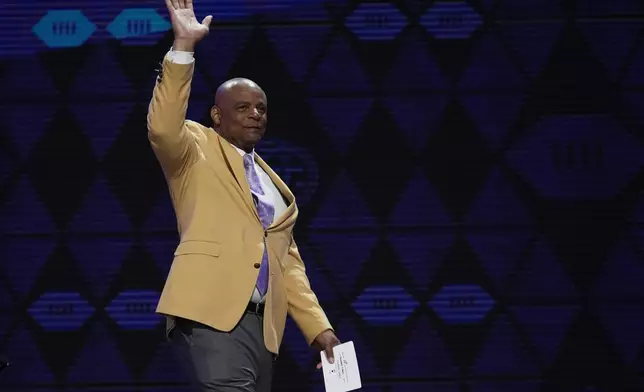 Former player Warren Moon walks on stage to announce a pick for the Tennessee Titans during the second round of the NFL football draft, Friday, April 26, 2024, in Detroit. (AP Photo/Jeff Roberson)