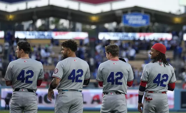 Members of the Washington Nationals wear No. 42 in honor of Jackie Robinson at a baseball game against the Los Angeles Dodgers, Monday, April 15, 2024, in Los Angeles. (AP Photo/Marcio Jose Sanchez)