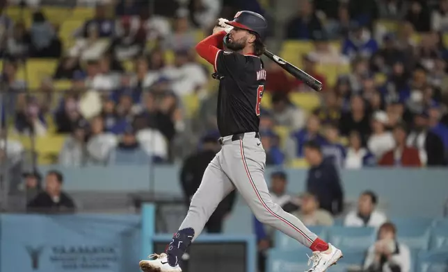 Washington Nationals' Jesse Winker watches his two-run home run against the Los Angeles Dodgers during the third inning of a baseball game Tuesday, April 16, 2024, in Los Angeles. (AP Photo/Marcio Jose Sanchez)