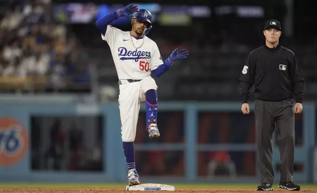 Los Angeles Dodgers' Mookie Betts reacts after driving in a run with a double during the second inning of the team's baseball game against the Washington Nationals, Tuesday, April 16, 2024, in Los Angeles. (AP Photo/Marcio Jose Sanchez)