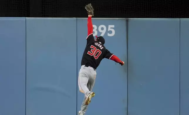 Washington Nationals center fielder Jacob Young makes a leaping catch on a line drive by Los Angeles Dodgers' Austin Barnes during the fourth inning of a baseball game Tuesday, April 16, 2024, in Los Angeles. (AP Photo/Marcio Jose Sanchez)