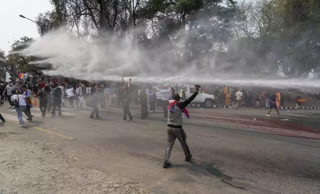 Nepalese police use water cannon to disperse supporters of Rastriya Prajatantra Party, or national democratic party during a protest demanding a restoration of Nepal's monarchy in Kathmandu, Nepal, Tuesday, April 9, 2024. Riot police used batons and tear gas to halt thousands of supporters of Nepal's former king demanding the restoration of the monarchy and the nation's former status as a Hindu state. Weeks of street protests in 2006 forced then King Gyanendra to abandon his authoritarian rule and introduce democracy. (AP Photo/Niranjan Shrestha)