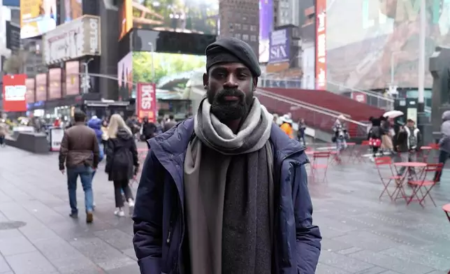 In this screen grab taken from video, Tunde Onakoya, 29- years old, a Nigerian chess champion and child education advocate, poses on the street in Times Square, New York, Thursday, April, 18, 2024. A Nigerian chess player and child education advocate is attempting to play chess nonstop for 58 hours in New York City's Times Square to break the global record for the longest chess marathon and raise $1m for the education of children across Africa. (AP Video/John Minchillo)