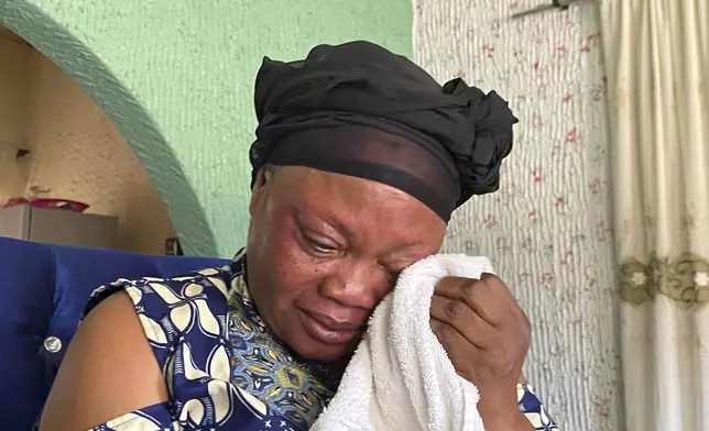 Mary Peter, mother of Jennifer Peter, who was kidnapped with others in her school by gunmen in March 2021, sobs during an interview with The Associated Press in Kaduna, Nigeria, Tuesday, March, 26, 2024. The gunmen who kidnapped Jennifer Peter and dozens of her peers from school in March 2021 returned months later to attack another school in her state in northwestern Nigeria. The second time, they seized over 100 children including Jennifer's 10-year-old cousin, Treasure, who was held captive for more than two years. (AP Photo/Chinedu Asadu)