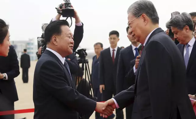 Choe Ryong Hae, left, vice-chairman of the central committee of the Workers' Party of North Korea, shakes hands with Zhao Leji, chairman of the National People’s Congress of China and considered the No. 3 official in the ruling Communist Party, as Zhao and other delegates arrive at the Pyongyang International Airport in Pyongyang, North Korea, Thursday, April 11, 2024. (AP Photo/Cha Song Ho)