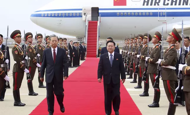 Choe Ryong Hae, center right, vice-chairman of the central committee of the Workers' Party of North Korea, escorts Zhao Leji, center left, chairman of the National People’s Congress of China and considered the No. 3 official in the ruling Communist Party, as Zhao and other delegates arrive at the Pyongyang International Airport in Pyongyang, North Korea, Thursday, April 11, 2024. (AP Photo/Cha Song Ho)