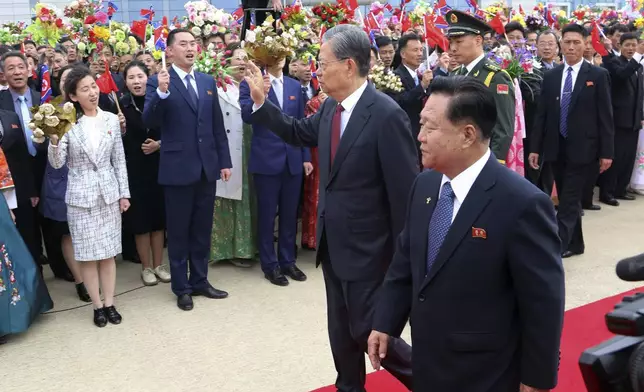 Zhao Leji, center, chairman of the National People’s Congress and considered the No. 3 official in the ruling Communist Party, waves as Choe Ryong Hae, front right, vice-chairman of the central committee of the Workers' Party of North Korea, and Pyongyang citizens welcome Zhao and other delegates upon their arrival at the Pyongyang International Airport in Pyongyang, North Korea, Thursday, April 11, 2024. (AP Photo/Cha Song Ho)