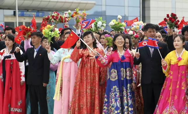 Pyongyang citizens welcome a Chinese delegation headed by Zhao Leji, chairman of the National People’s Congress and considered the No. 3 official in the ruling Communist Party, as they arrive at the Pyongyang International Airport in Pyongyang, North Korea, Thursday, April 11, 2024. (AP Photo/Cha Song Ho)