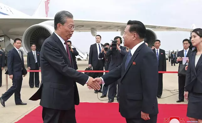 In this photo provided on April 12, 2024, by the North Korean government, Choe Ryong Hae, front right, vice-chairman of the central committee of the Workers' Party of North Korea, shakes hands with Zhao Leji, center left, chairman of the National People’s Congress of China, as Zhao and other delegates arrive at the Pyongyang International Airport in Pyongyang, North Korea, Thursday, April 11, 2024. Korean language watermark on image as provided by source reads: "KCNA" which is the abbreviation for Korean Central News Agency. (Korean Central News Agency/Korea News Service via AP)