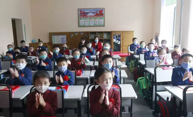 FILE - Students wearing face masks take a class at Kim Song Ju Primary School in Pyongyang, North Korea, on June 3, 2020. North Korea is putting surveillance cameras in schools and workplaces, and collecting fingerprints, photographs and other biometric information from its citizens in a technology-driven push to monitor its population even more closely, a report said Tuesday, April 16, 2024. (AP Photo/Cha Song Ho, File)