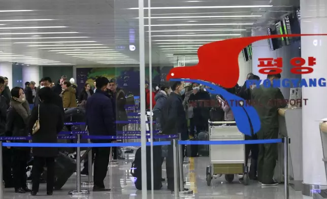 FILE - Passengers wearing masks as a precaution against the new coronavirus line up to check in for a flight to Vladivostok, Russia, at the Pyongyang International Airport in Pyongyang, North Korea, March 9, 2020. North Korea is putting surveillance cameras in schools and workplaces, and collecting fingerprints, photographs and other biometric information from its citizens in a technology-driven push to monitor its population even more closely, a report said Tuesday, April 16, 2024. (AP Photo/Jon Chol Jin, File)