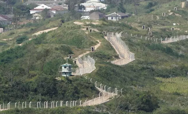 FILE - Guard posts and fences ring a hill side on the North Korea border with Russia and China seen from China's Yiyanwang Three Kingdoms viewing platform in Fangchuan in northeastern China's Jilin province on Sept. 12, 2023. North Korea is putting surveillance cameras in schools and workplaces, and collecting fingerprints, photographs and other biometric information from its citizens in a technology-driven push to monitor its population even more closely, a report said Tuesday, April 16, 2024.(AP Photo/Ng Han Guan, File)