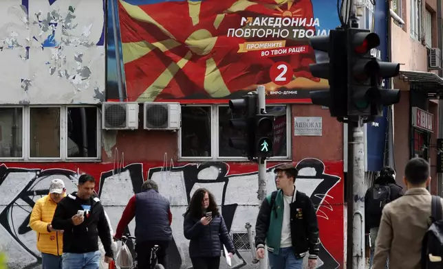 An election poster of the center-right main opposition VMRO-DPMNE coalition, is displayed on a building in Skopje, North Macedonia, on Monday April 22, 2024. Voters go to the polls in North Macedonia on Wednesday April 24 for the first round of presidential elections, the seventh such election since the Balkan country gained independence from the former Yugoslavia in 1991, where seven candidates are vying for the largely ceremonial position. (AP Photo/Boris Grdanoski)