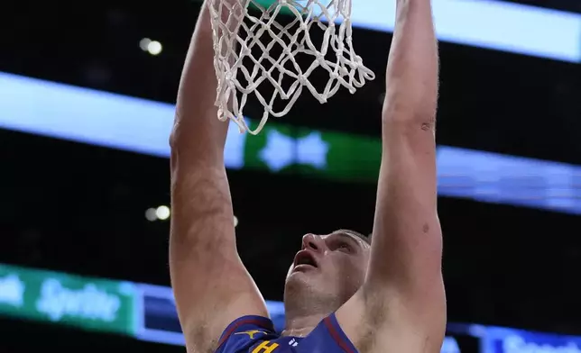 Denver Nuggets center Nikola Jokic (15) dunks during the first half of Game 3 of an NBA basketball first-round playoff series against the Los Angeles Lakers in Los Angeles, Thursday, April 25, 2024. (AP Photo/Ashley Landis)