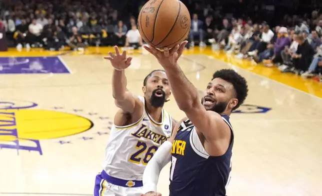 Denver Nuggets guard Reggie Jackson, right, shoots as Los Angeles Lakers guard Spencer Dinwiddie defends during the second half in Game 4 of an NBA basketball first-round playoff series Saturday, April 27, 2024, in Los Angeles. (AP Photo/Mark J. Terrill)