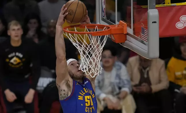 Denver Nuggets forward Aaron Gordon (50) dunks during the first half of Game 3 of an NBA basketball first-round playoff series against the Los Angeles Lakers in Los Angeles, Thursday, April 25, 2024. (AP Photo/Ashley Landis)