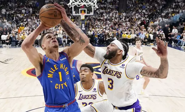 Denver Nuggets forward Michael Porter Jr. (1) goes up to shoot against Los Angeles Lakers forward Anthony Davis (3) during the first half in Game 1 of an NBA basketball first-round playoff series, Saturday, April 20, 2024, in Denver. (AP Photo/Jack Dempsey)