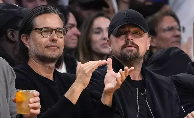 Actor Leonardo DiCaprio, right, watches during the second half in Game 4 of an NBA basketball first-round playoff series between the Los Angeles Lakers and the Denver Nuggets Saturday, April 27, 2024, in Los Angeles. (AP Photo/Mark J. Terrill)