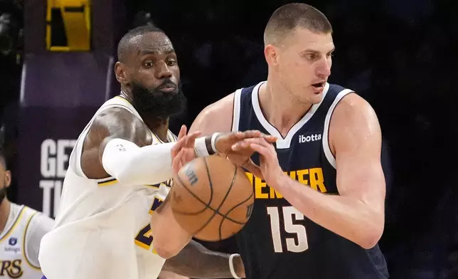 Los Angeles Lakers forward LeBron James, left, knocks the ball from the hands of Denver Nuggets center Nikola Jokic during the second half in Game 4 of an NBA basketball first-round playoff series Saturday, April 27, 2024, in Los Angeles. (AP Photo/Mark J. Terrill)