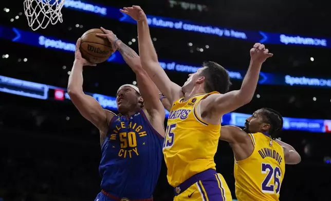 Denver Nuggets forward Aaron Gordon (50) shoots against Los Angeles Lakers guard Austin Reaves (15) during the first half of Game 3 of an NBA basketball first-round playoff series in Los Angeles, Thursday, April 25, 2024. (AP Photo/Ashley Landis)