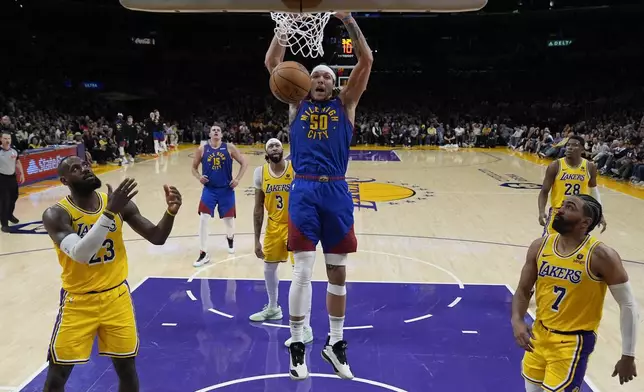 Denver Nuggets forward Aaron Gordon (50) dunks during the second half of Game 3 of an NBA basketball first-round playoff series against the Los Angeles Lakers in Los Angeles, Thursday, April 25, 2024. (AP Photo/Ashley Landis)
