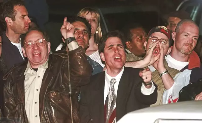 FILE - Members of the crowd react to O.J. Simpson leaving Los Angeles County Superior Court, Tuesday, Feb. 4, 1997, in Santa Monica, Calif. after hearing the verdict in the wrongful-death civil trial against O.J. Simpson. Simpson, the decorated football superstar and Hollywood actor who was acquitted of charges he killed his former wife and her friend but later found liable in a separate civil trial, has died. He was 76. (AP Photo/Susan Sterner, File)