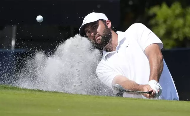 FILE - Scottie Scheffler hits out of the sand on the second green during the final round of The Players Championship golf tournament Sunday, March 17, 2024, in Ponte Vedra Beach, Fla. (AP Photo/Marta Lavandier, File)