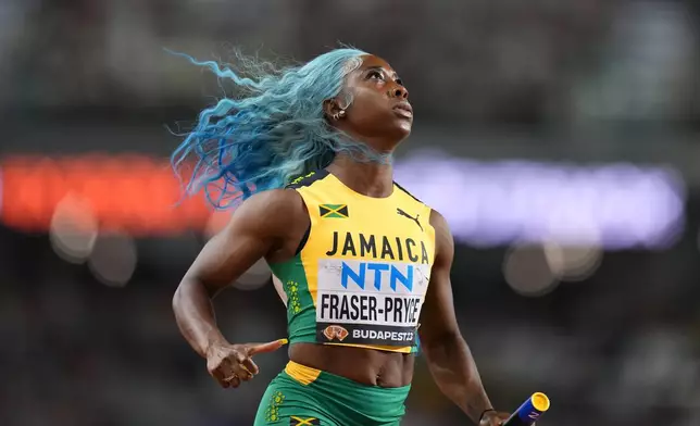 FILE - Shelly-Ann Fraser-Pryce, of Jamaica anchors her team to win a Women's 4x100-meters relay heat during the World Athletics Championships in Budapest, Hungary, Friday, Aug. 25, 2023. (AP Photo/Petr David Josek, File)