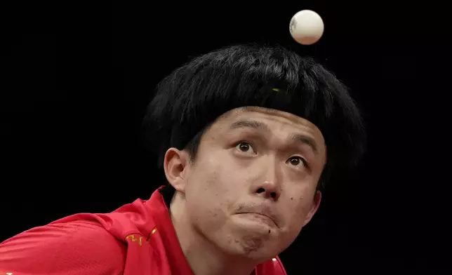 FILE - China's Wang Chuqin eyes the ball as he serves against his compatriot Fan Zhendong during their Table Tennis Men's Singles Final match for the 19th Asian Games in Hangzhou, Monday, Oct. 2, 2023. (AP Photo/Ng Han Guan, File)