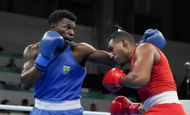 FILE - Cuba's Arlen Lopez, right, and Brazil's Wanderley De Souza compete in the men' 80kg boxing gold medal bout, at the Pan American Games in Santiago, Chile, Friday, Oct. 27, 2023.(AP Photo/Martin Mejia, File)