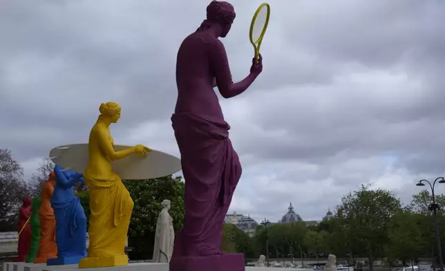 Copies of one of the most famous Greek statues, the Venus of Milo, are installed on the steps of the French National Assembly in Paris, France, Monday, April 15, 2024, to celebrate the Olympic spirit. The Venus, by artist Laurent Perbos, has regained her arms and is now equipped with the attributes of six sporting disciplines. (AP Photo/Christophe Ena)