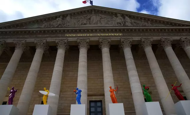 Copies of one of the most famous Greek statues, the Venus of Milo, are installed on the steps of the French National Assembly in Paris, France, Monday, April 15, 2024, to celebrate the Olympic spirit. The Venus, by artist Laurent Perbos, has regained her arms and is now equipped with the attributes of six sporting disciplines. (AP Photo/Christophe Ena)