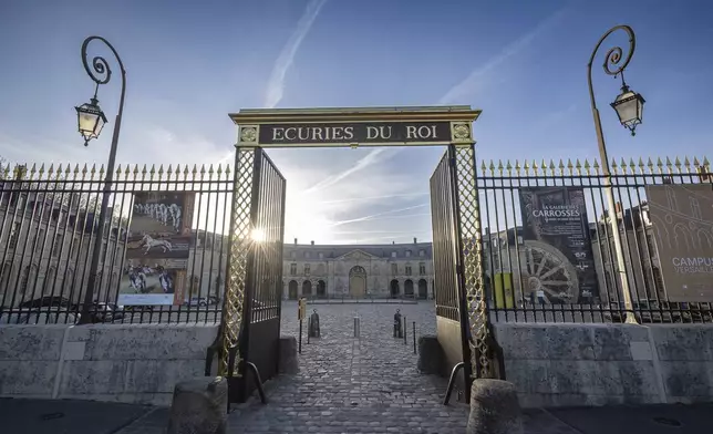 The entrance to the royal stables, in Versailles, Thursday, April 25, 2024. More than 340 years after the royal stables were built under the reign of France's Sun King, riders and horses continue to train and perform in front of the Versailles Palace. The site will soon keep on with the tradition by hosting the equestrian sports during the Paris Olympics. Commissioned by King Louis XIV, the stables have been built from 1679 to 1682 opposite to the palace's main entrance. (AP Photo/Aurelien Morissard)