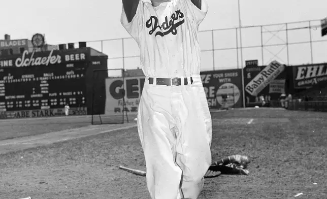 FILE - Brooklyn Dodgers pitcher Carl Erskine shows his form in New York, May 10, 1951. Carl Erskine, who pitched two no-hitters as a mainstay on the Brooklyn Dodgers and was a 20-game winner in 1953 when he struck out a then-record 14 in the World Series, died Tuesday, April 16, 2024, at Community Hospital Anderson in Anderson, Indiana, according to Michele Hockwalt, the hospital’s marketing and communication manager. He was 97. (AP Photo/John Rooney, File)