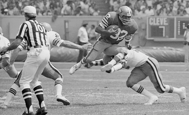 San Francisco 49er O.J. Simpson takes to the air as Cleveland Brown's Thom Darden makes the tackle during the second quarter of an NFL football game, Sept. 3, 1978, in Cleveland, Ohio. Simpson, the decorated football superstar and Hollywood actor who was acquitted of charges he killed his former wife and her friend but later found liable in a separate civil trial, died Wednesday, April 11, 2024, of prostate cancer. He was 76. (AP Photo/File)