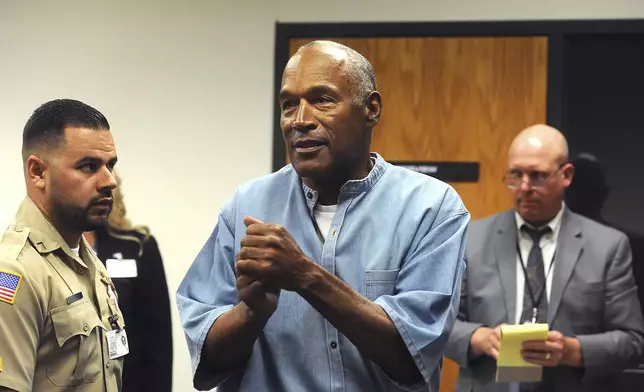 FILE - In this July 20, 2017 file photo, former NFL football star O.J. Simpson reacts after learning he was granted parole at Lovelock Correctional Center in Lovelock, Nev. Simpson, the decorated football superstar and Hollywood actor who was acquitted of charges he killed his former wife and her friend but later found liable in a separate civil trial, has died. He was 76. (Jason Bean/The Reno Gazette-Journal via AP, Pool, File)