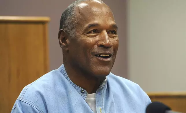 FILE - Former NFL football star O.J. Simpson appears via video for his parole hearing at the Lovelock Correctional Center in Lovelock, Nev., on July 20, 2017. Simpson, the decorated football superstar and Hollywood actor who was acquitted of charges he killed his former wife and her friend but later found liable in a separate civil trial, has died. He was 76. (Jason Bean/The Reno Gazette-Journal via AP, Pool, File)
