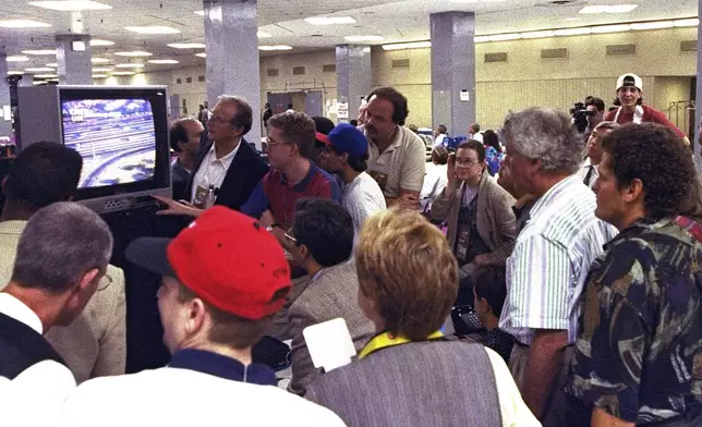 FILE - Members of the news media watch live television coverage of the O.J. Simpson slow speed chase on Los Angeles freeways during Game 5 of the NBA finals Friday night, June 17, 1994, at New York's Madison Square Garden. Simpson, the decorated football superstar and Hollywood actor who was acquitted of charges he killed his former wife and her friend but later found liable in a separate civil trial, died Wednesday, April 11, 2024, of prostate cancer. He was 76. (AP Photo/Ron Frehm, File)