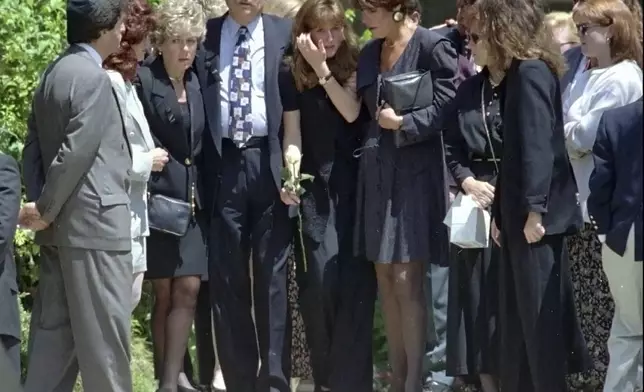FILE - Fred Goldman, left center, is flanked by his wife, Patti, left, and daughter Kim, center, as they leave the Valley Oaks Memorial Park in Westlake Village, Calif., Thursday, June 16,1994, after attending the funeral services for their son, Ronald Goldman, who was killed at Nicole Brown Simpson's Los Angeles-area condominium oOn June 12, 1994. O.J. Simpson, the decorated football superstar and Hollywood actor who was acquitted of charges he killed his former wife and her friend but later found liable in a separate civil trial, has died. He was 76. (AP Photo/Kevork Djansezian, File)
