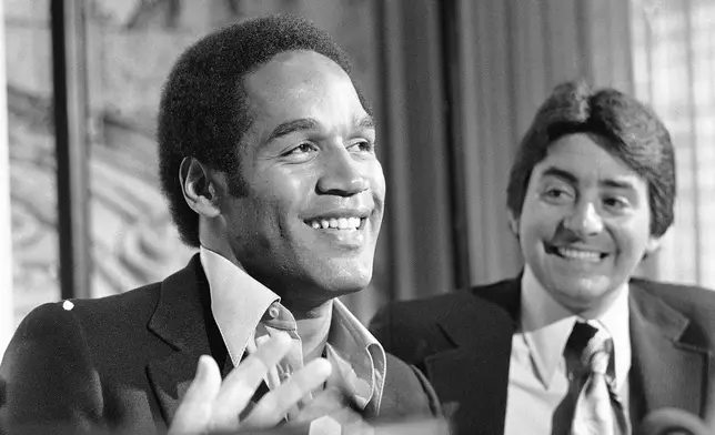 FILE - O.J. Simpson speaks to the media about being traded from the Buffalo Bills to the San Francisco 49ers as 49ers owner Edward DeBartolo Jr. looks on during a press conference in San Francisco, March 24, 1978. O.J. Simpson, the decorated football superstar and Hollywood actor who was acquitted of charges he killed his former wife and her friend but later found liable in a separate civil trial, has died. He was 76. Simpson's attorney confirmed to TMZ he died Wednesday night, April 10, 2024, in Las Vegas.(AP Photo/Sal Veder, File)
